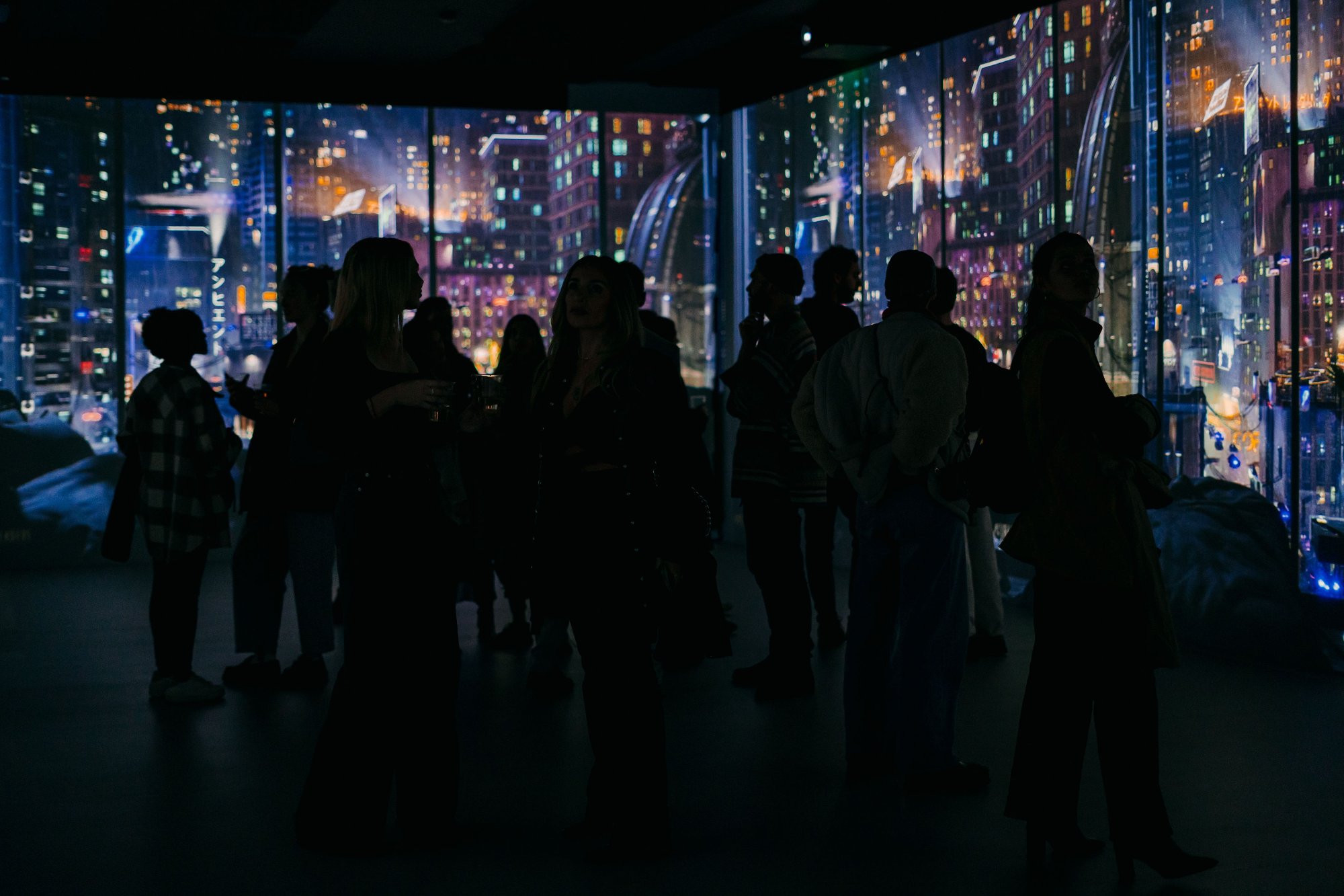 Silhouettes in SABDA's 360° immersive room during an event